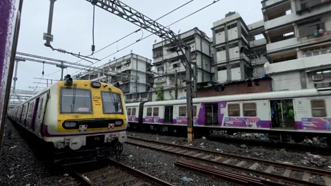 Mumbai local train with Rainy day view of the railway tracks in India Stock Footage 338047152