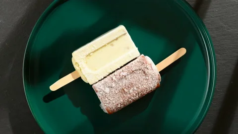 Mung bean and red bean popsicles melting on a dish timelapse 8K Stock Footage 138314471