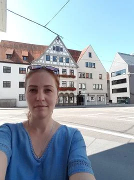 Munich , GERMANY - August 11 , 2019: beautiful red-haired female tourist take Stock Photos