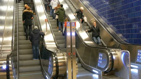 Munich, Germany - December 2, 2018: Large modern staircase escalator rides in Stock Footage 119889898