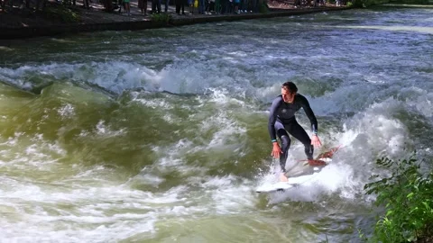 Munich, Germany - Jun 27, 2022: Surfer in the city river called Eisbach Stock Footage 202979665