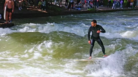 Munich, Germany - Jun 27, 2022: Surfer in the city river called Eisbach Stock Footage 202981922