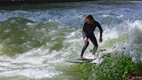 Munich, Germany - May 27, 2022: Surfer in the city river called Eisbach Stock Footage 195937665
