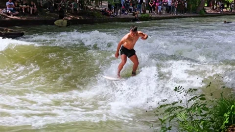 Munich, Germany - May 27, 2022: Surfer in the city river called Eisbach Stock Footage 196549682