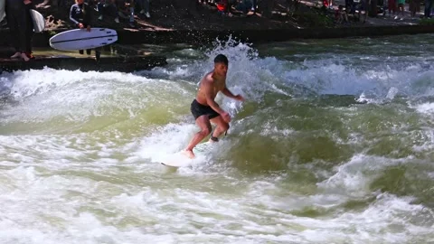 Munich, Germany - May 27, 2022: Surfer in the city river called Eisbach Stock Footage 201157155