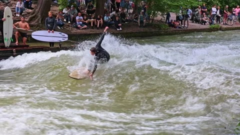 Munich, Germany - May 27, 2022: Surfer in the city river called Eisbach Stock Footage 201157532