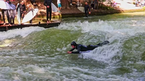 Munich, Germany - May 27, 2022: Surfer in the city river called Eisbach Stock-Footage 201157914