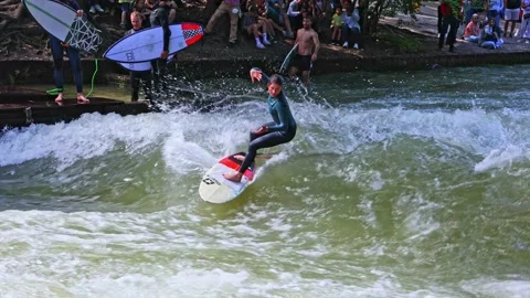 Munich, Germany - May 27, 2022: Surfer in the city river called Eisbach Stock Footage 201158060