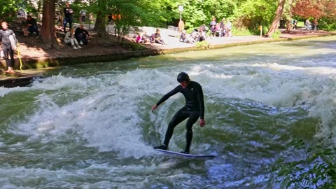 Munich, Germany - May 27, 2022: Surfer in the city river called Eisbach Stock Footage 201158178