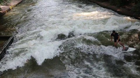 MUNICH, GERMANY - Munich, surfer rides an artificial wave Stock Footage 100990123