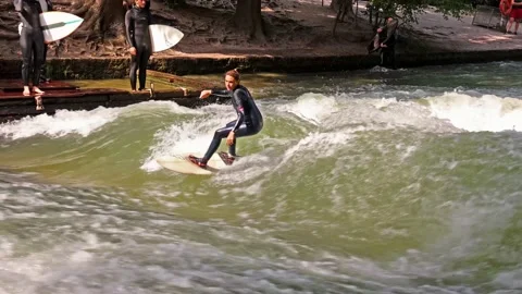 Munich, Germany - Sep 09, 2021: Surfer in the city river called Eisbach Stock Footage 161153553