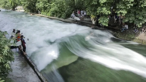 Munich: Timelapse Surfing in Eisbach Stock Footage 77249078