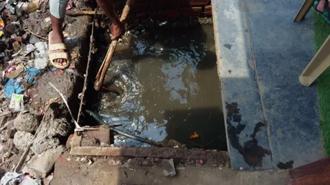Municipal outlet is physically maintained to remove clogs Stock Footage 312724354