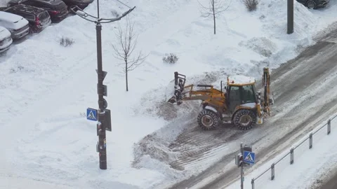 Municipal snow removal operation utilizing city trucks through winter streets Stock Footage 327237618