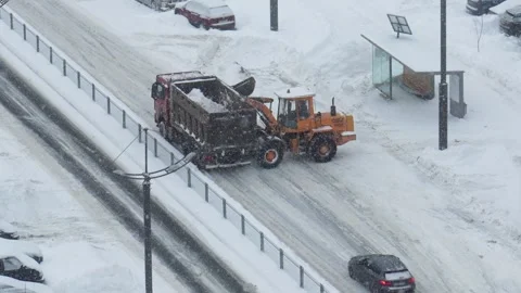 Municipal staff systematically clear snow to keep roads functional Stock Footage 327650017