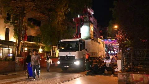 Municipal workers empty garbage containers with a truck. Stock Footage 296103218