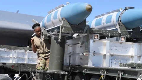 Munitions airman directing bomb loader operator during off-loading Stock Footage 112124967