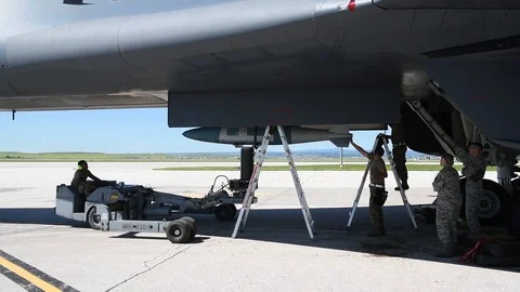 Munitions Airman loading ordnance into B2 Lancer with bomb loader Stock Footage 112125081