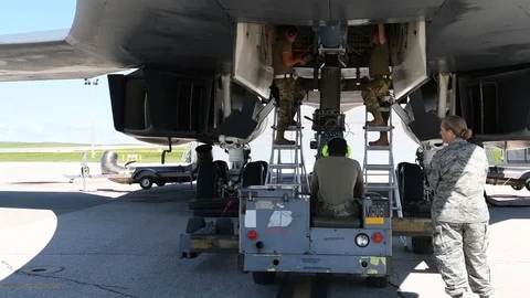 Munitions airmen loading bomb into B2 Lancer with bomb loader 動画素材 112125010