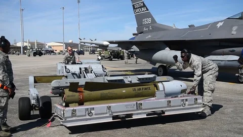 Munitions being lifted by bomb loader during building and loading program Stock Footage 83308749