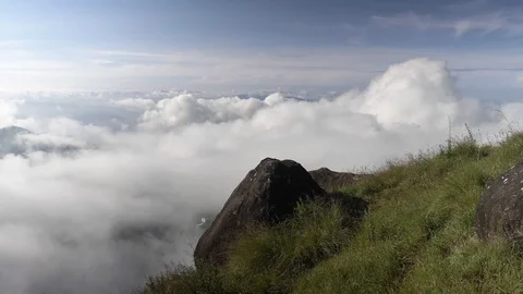 MUNNAR, India - pan from cloudscape revealing people walking in the hills Stock Footage 86294211