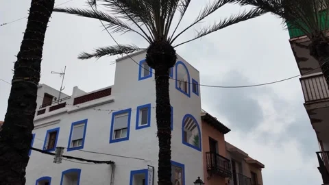 Mural artwork on building side with blowing palm trees, Calpe, Spain Stock Footage 342317880