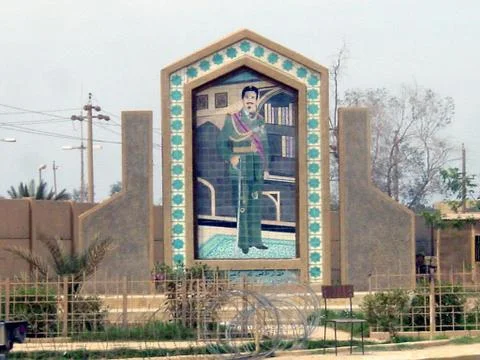 Mural of former Iraqi President Saddam Hussein stands at a roadside site - 2003 Stock Photos