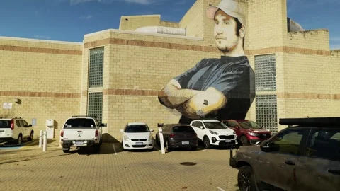 Mural of a man on Perth building and parked cars tracking shot 6K Vídeos de archivo 311993675