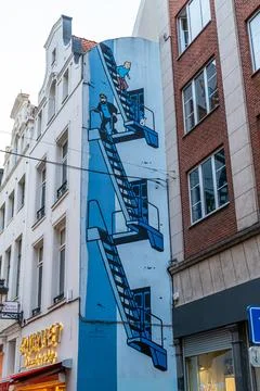 Mural of Tintin comic book Captain Haddock and dog Snowball climbing an out.. Stock Photos