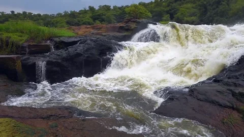 Murchison Falls Raging Water Cascading over Dark Rocky Cliffs in 4k Stock Footage 338263902