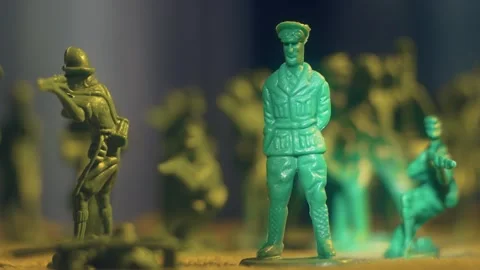 Murder of army general imitation, man knocks over plastic toy soldier with snap Stock Footage 242015164
