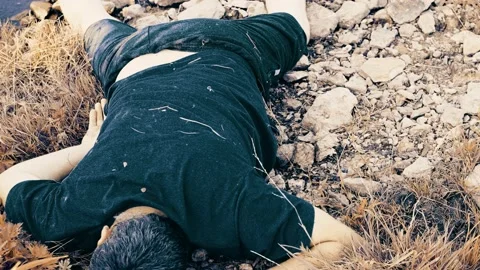 Murder by the river , the body of a young man aged lies by the water, a corpse b Video stock 162699202