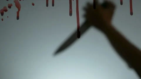 Murder scene with hand stabbing someone with a knife and red blood splashing. Stock Footage 132090985