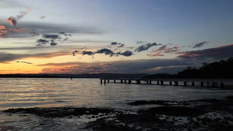 Murrays beach cams wharf beach boat jetty at sunset as 4k time lapse. Stock Footage 238645993