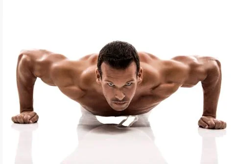 Muscle man dmaking push ups in studio, isolated over a white background Stock Photos