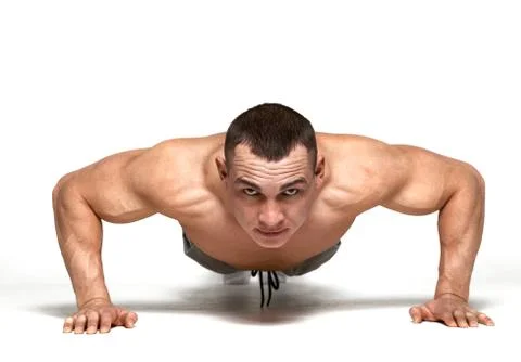 Muscle man making push ups in studio over  white background Stock Photos