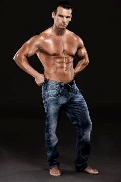 Muscle man posing in studio, isolated over a white background Stock Photos