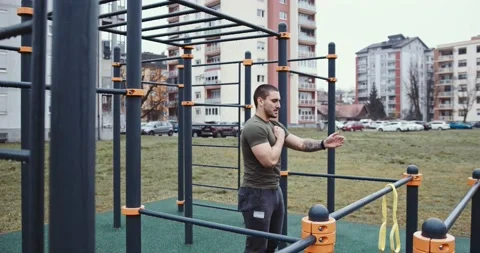 Muscle man using Bands for Warming up, outdoor fitness Stock Footage 145348058
