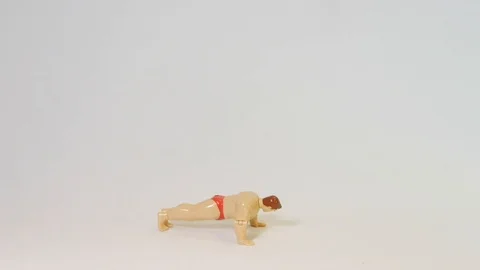 Muscle Man Wind up Toy Doing Push Ups Stock Footage 100692297