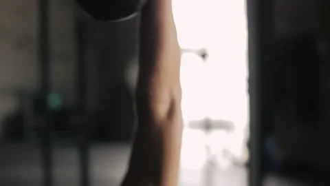 Muscled man performs acrobatic weight lifting in gym environment Stock Footage 312764716