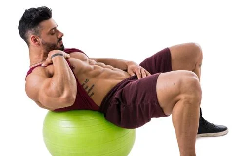 Muscleman exercising abs on an exercise ball Stock Photos