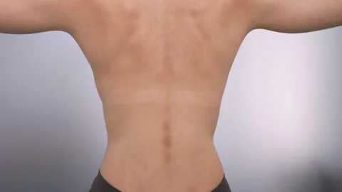 Muscles on woman's nude back Stock Footage 113404932