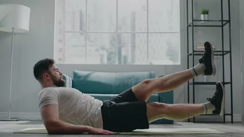 Muscular athlete with beard practices flutter kicks exercise Stock Footage 152733965