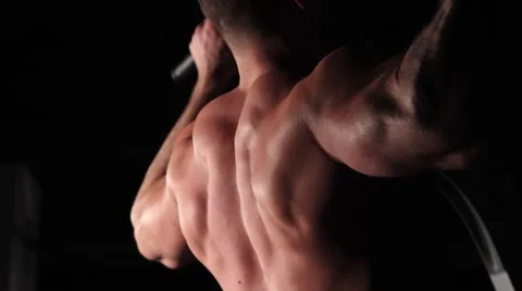 Muscular athlete does an exercise to pump the sphene muscles Stock Footage 62022911