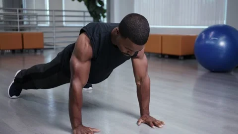 Muscular athlete does push ups, intense work out at home Stock Footage 133536655