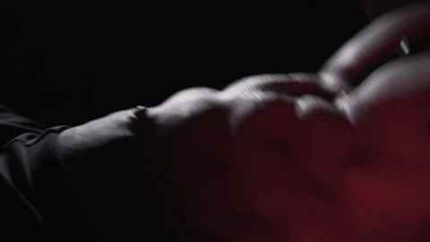 Muscular athlete doing abs workout in dark gym Stock Footage 314680987
