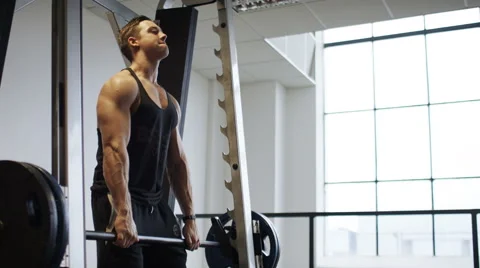 Muscular athlete using heavy weights bar in the gym Stock Footage 59866481