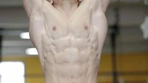 Muscular athletic man doing abs crunches in the gym. Abdominal muscles workout Video stock 169598473