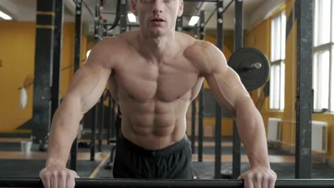 Muscular athletic man doing push-ups in the gym Stock Footage 170500429