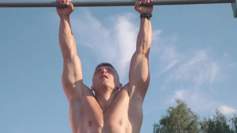Muscular athletic young man doing pull up on the horizontal bar. Sport and he Stock-Footage 159471599